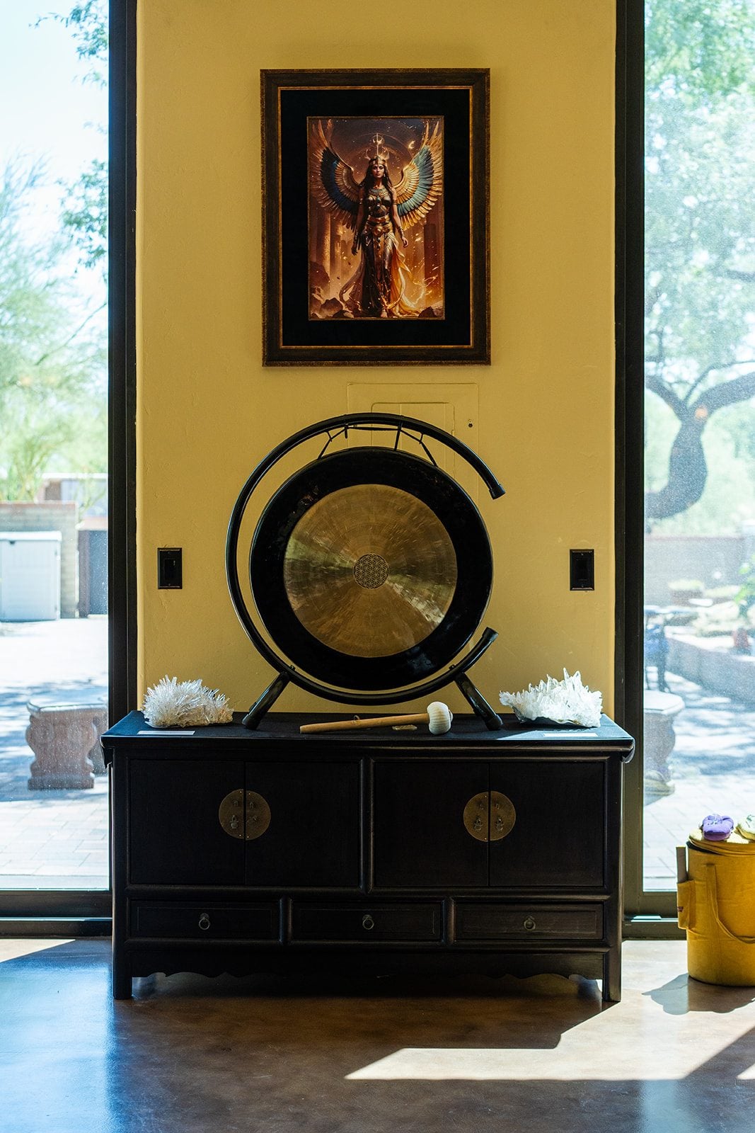 The gong on its stand between the glass doors