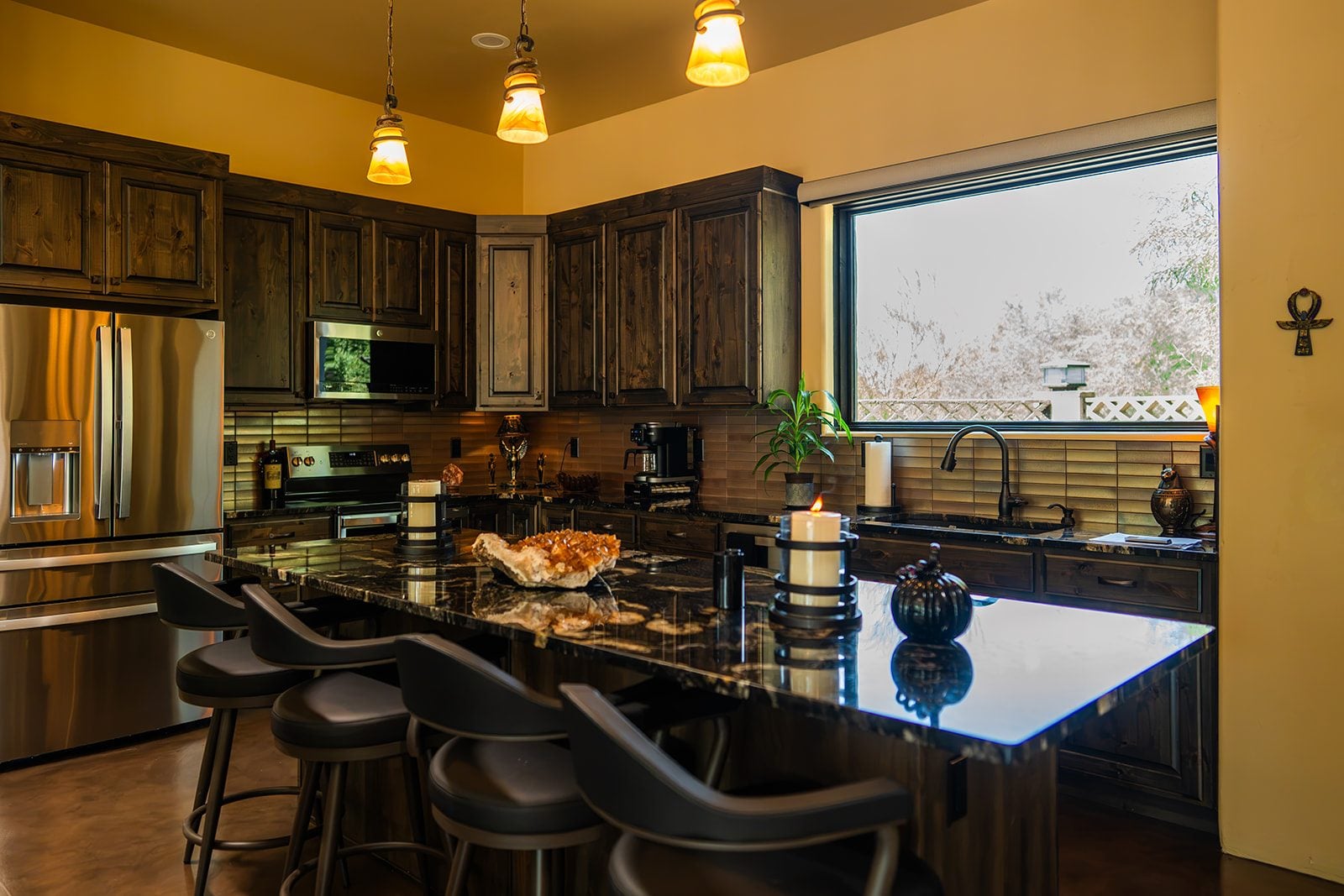 The kitchen with its long black granite island