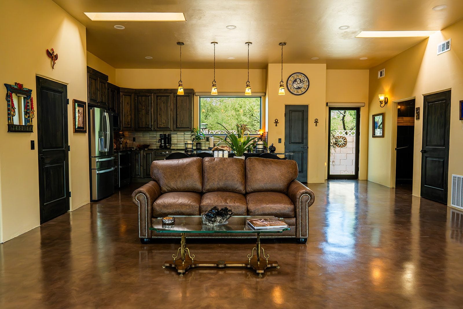 The open gathering room with leather sofas and the glass doors