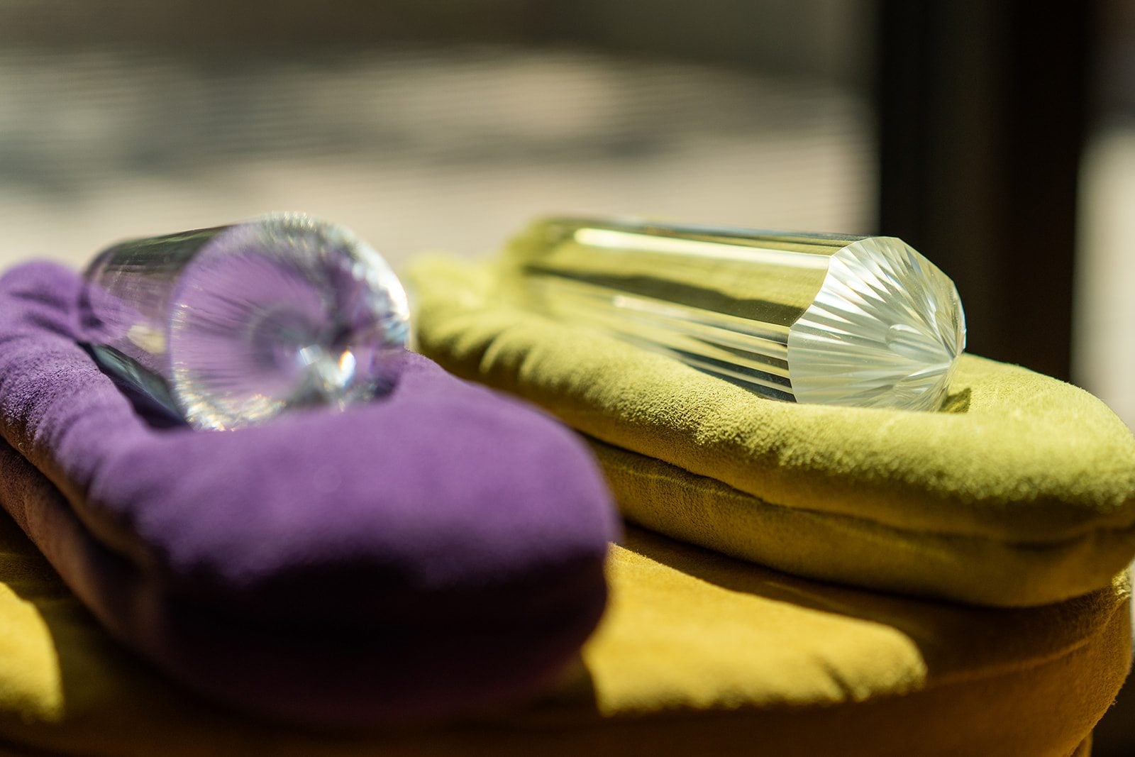 Two Vogel crystals resting on velvet cushions